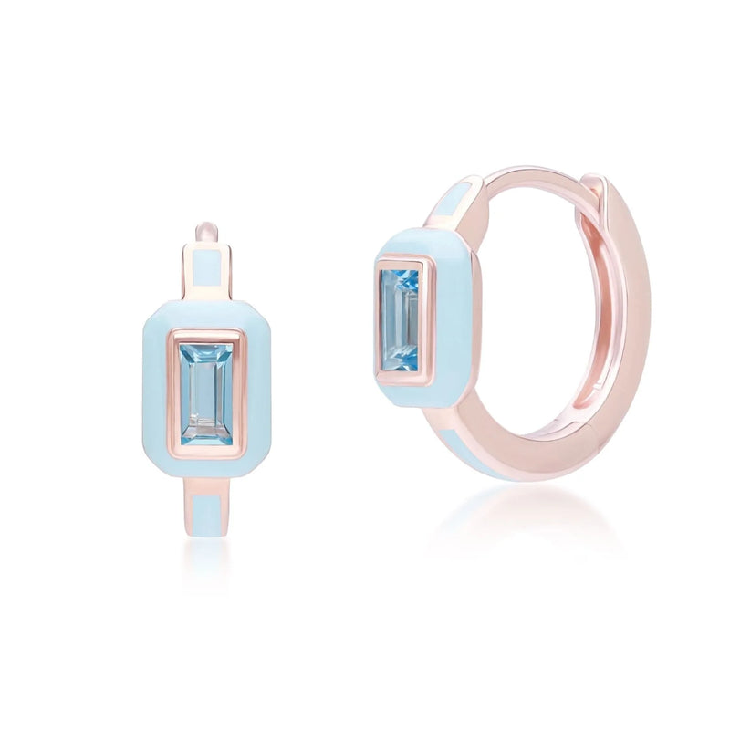 Pair of earrings with blue gemstones and rose gold accents on a white background