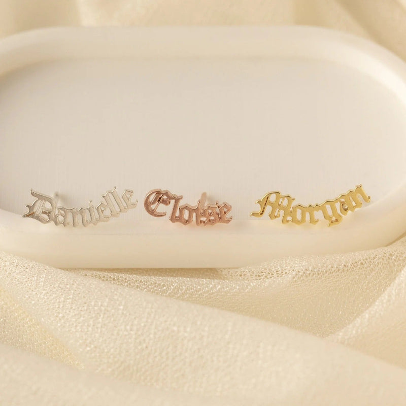 Three gold nameplates with names 'Danielle', 'Cloise', and 'Morgan' on a beige background.