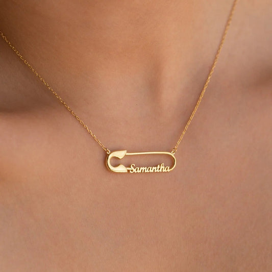 Gold necklace with a 'Samantha' pendant on a blurred background