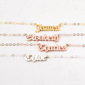 Gold, rose gold, and silver name bracelets on a white background