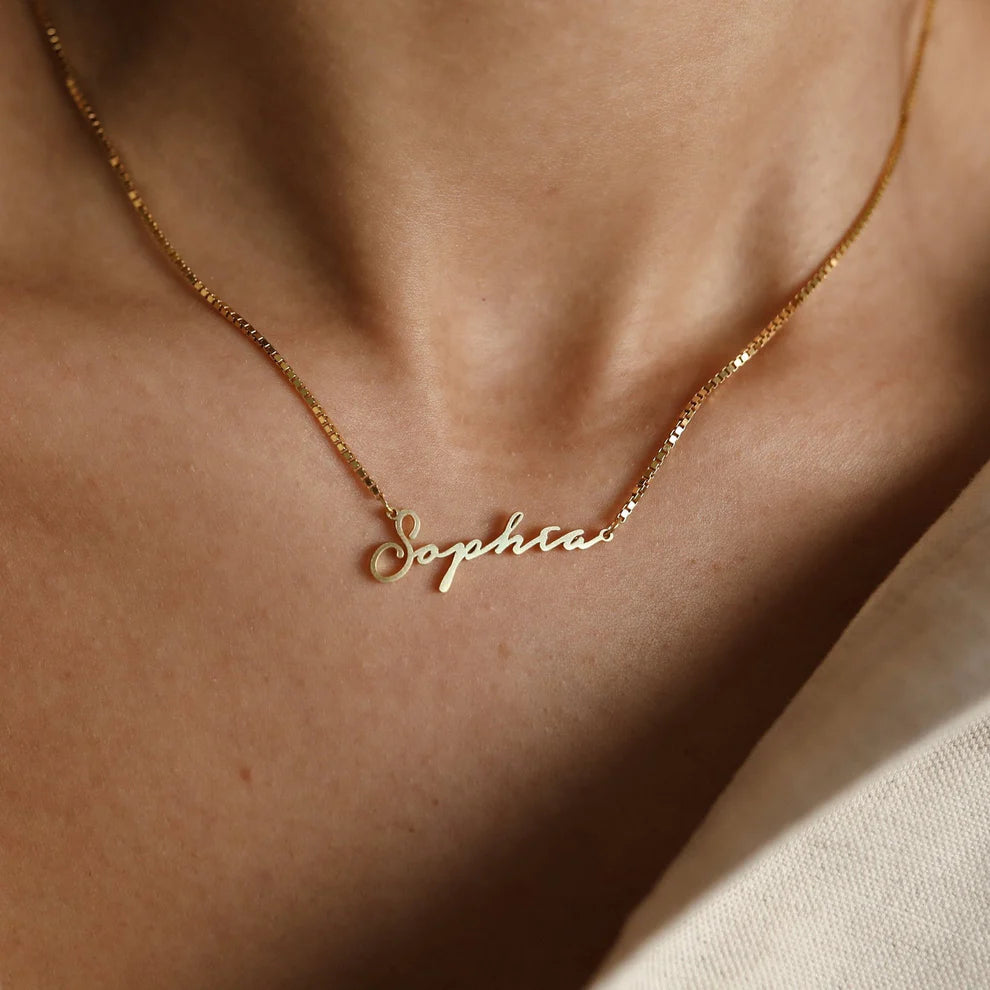 Gold necklace with 'Sophia' pendant on a person's neck