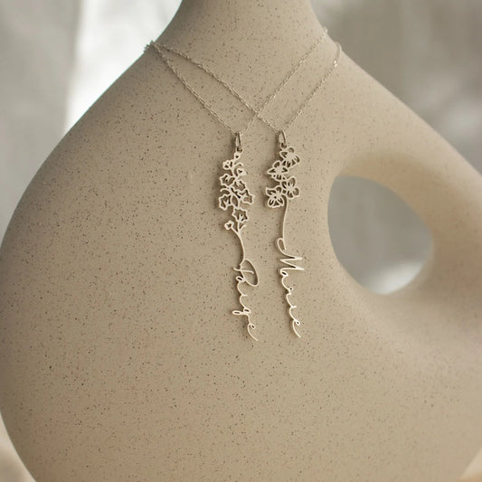 Gold necklace and earrings on a mannequin bust with a neutral background