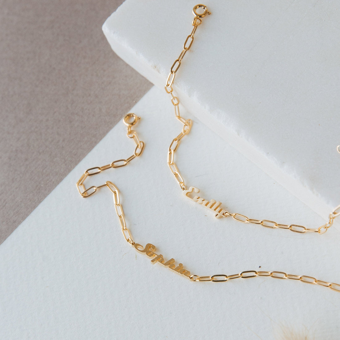 Gold chain necklace on a white surface